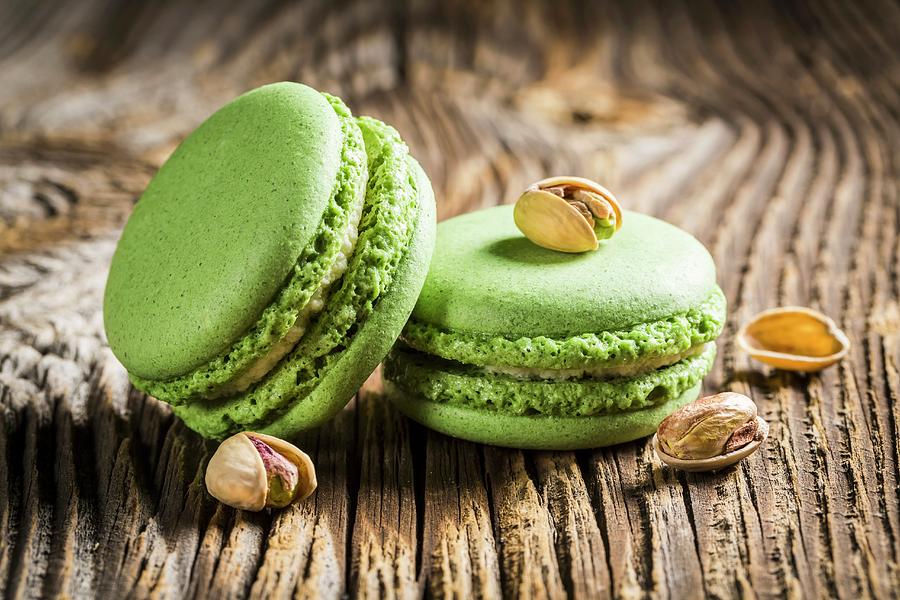 Green Pistachio Macaroons On A Wooden Table Photograph by Shaiith