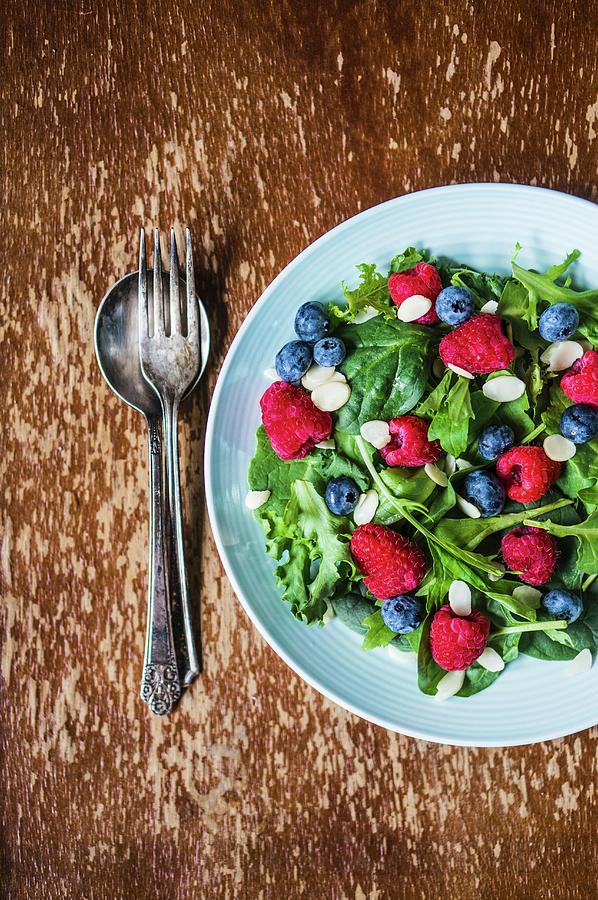 Green Salad With Rocket, Berries And Flaked Almonds Photograph by Alena Haurylik