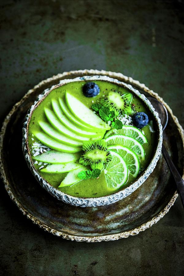 Green Smoothie Bowl With Spinach, Banana, Apple, Coconut Water, Limes, Kiwi Flowers And Blueberries Photograph by Alena Haurylik