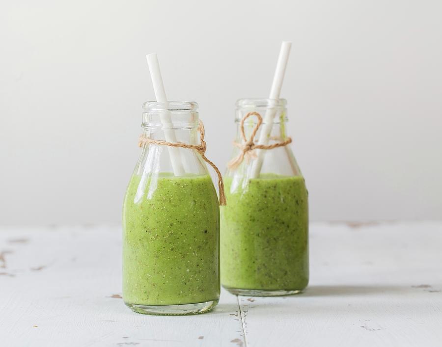 Green Smoothies With Avocado, Kiwi, Spinach, Ginger And Chia Seeds In Bottles Photograph by Cath Lowe