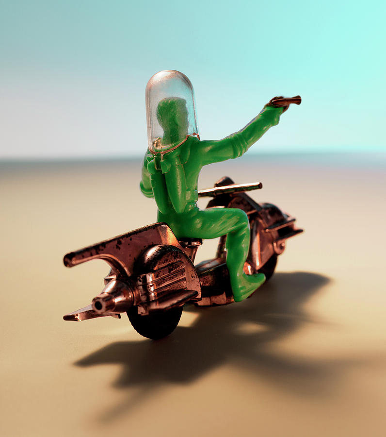 Science Fiction Drawing - Green Spaceman Riding Motorcycle With Gun by CSA Images