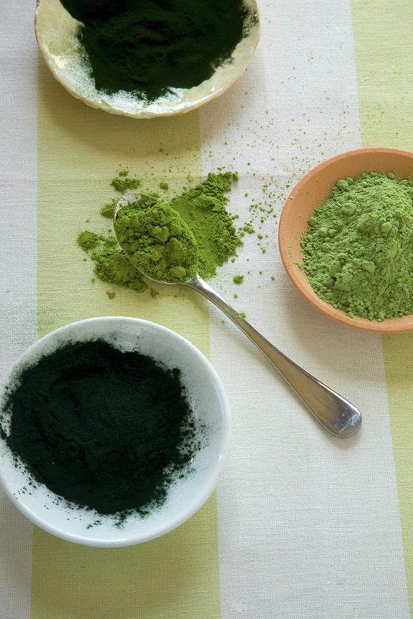 Green Superfood Powders In Bowls And On A Spoon Photograph by Joy Skipper Foodstyling