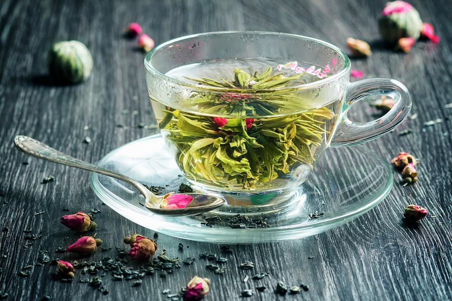 Green Tea In A Glass With A Tea Flower Photograph by Natasha Breen