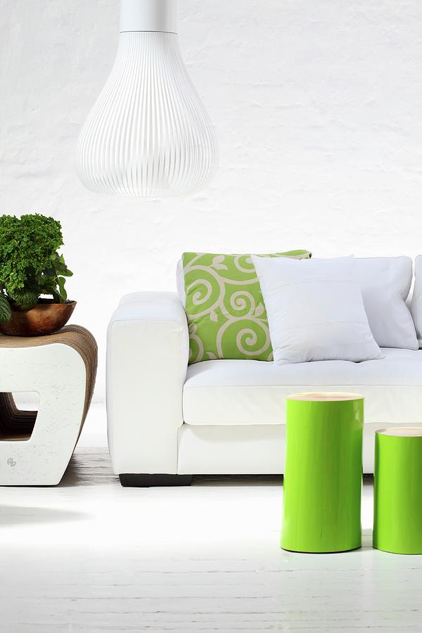 Green-varnished, Cylindrical Side Tables In Front Of White Sofa And Designer Pendant Lamp With White Slatted Lampshade Photograph by Great Stock!