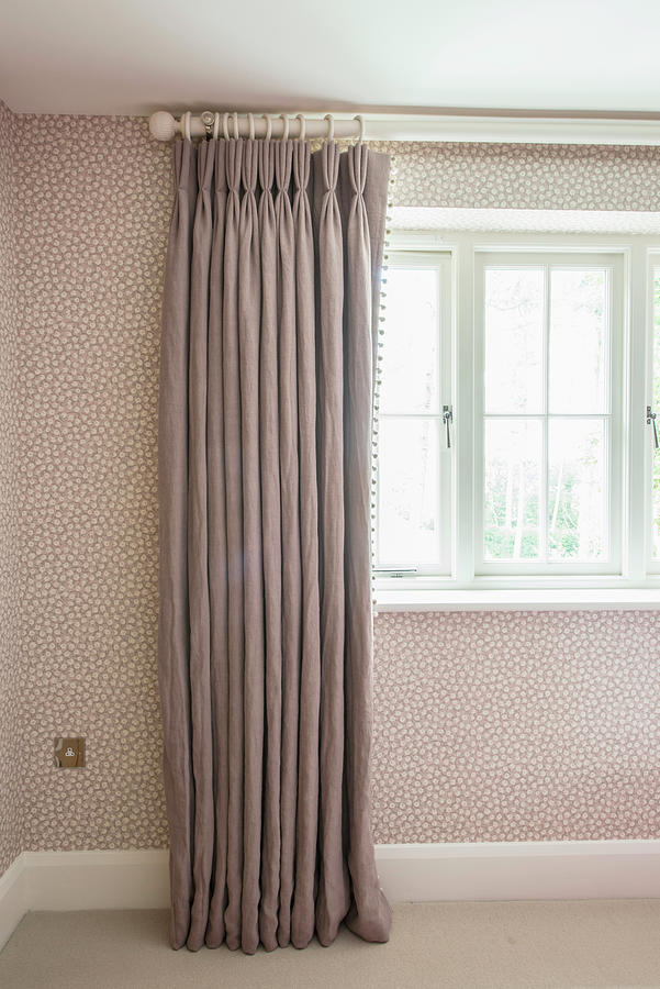 Grey Curtain Draped In Elegant Folds Against Spotted Wallpaper ...