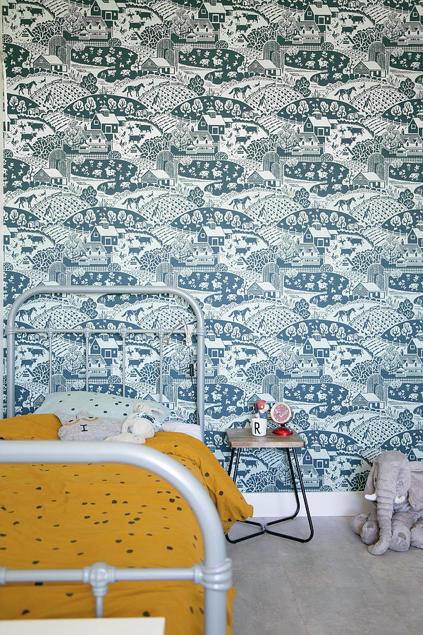 Grey Metal Bed Against Blue-patterned Retro Wallpaper Photograph by Ilaria Chiaratti