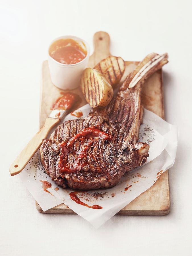 Grilled American Ribeye Steak, Tomahawk-style With Barbecue Sauce Photograph by Thorsten Kleine Holthaus
