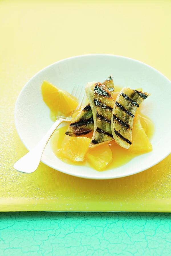 Grilled Banana With Orange Sauce Photograph by Michael Wissing