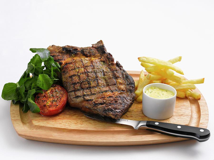 Grilled Beef Steak With Chips, Herb Butter And Tomatoes Photograph by Tim Winter