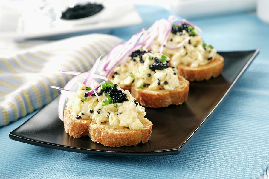 Grilled Bread Topped With Scrambled Eggs, Onions, Chives And Caviar Photograph by Gastromedia