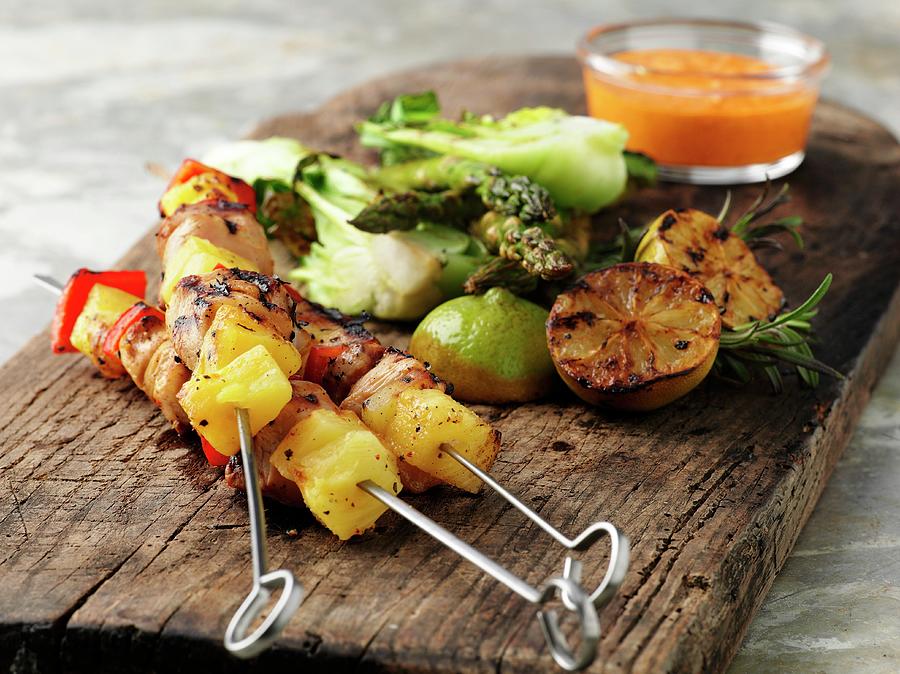 Grilled Chicken Skewers With Lemons And Vegetables On A Wooden Board Photograph by Pepe Nilsson