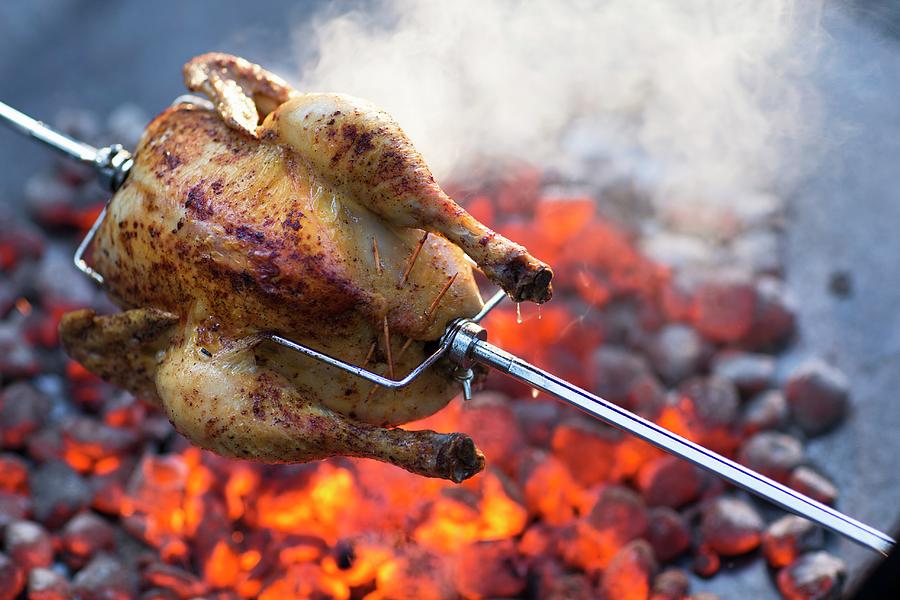 Grilled Chicken With An Almond And Mushroom Stuffing On A Spit Photograph by Jalag / Joerg Lehmann