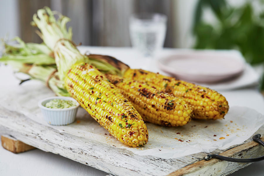 Grilled Corn Cobs On A Wooden Board Photograph by Kathrin Mccrea