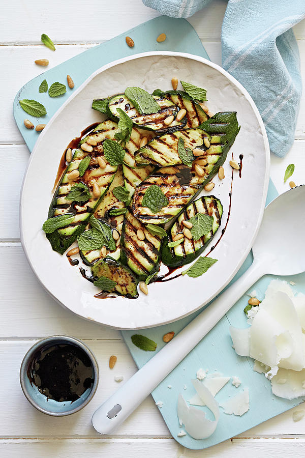 Grilled Courgettes Covered With Herbs And Pine Nuts Photograph by Steven Joyce
