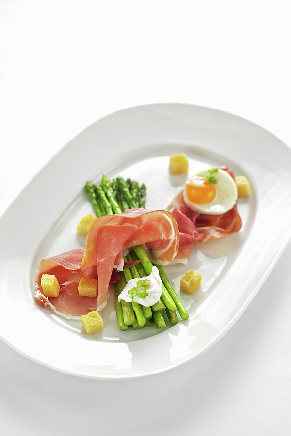 Grilled Green Asparagus With Raw Ham And Fried Egg Photograph by Herbert Lehmann