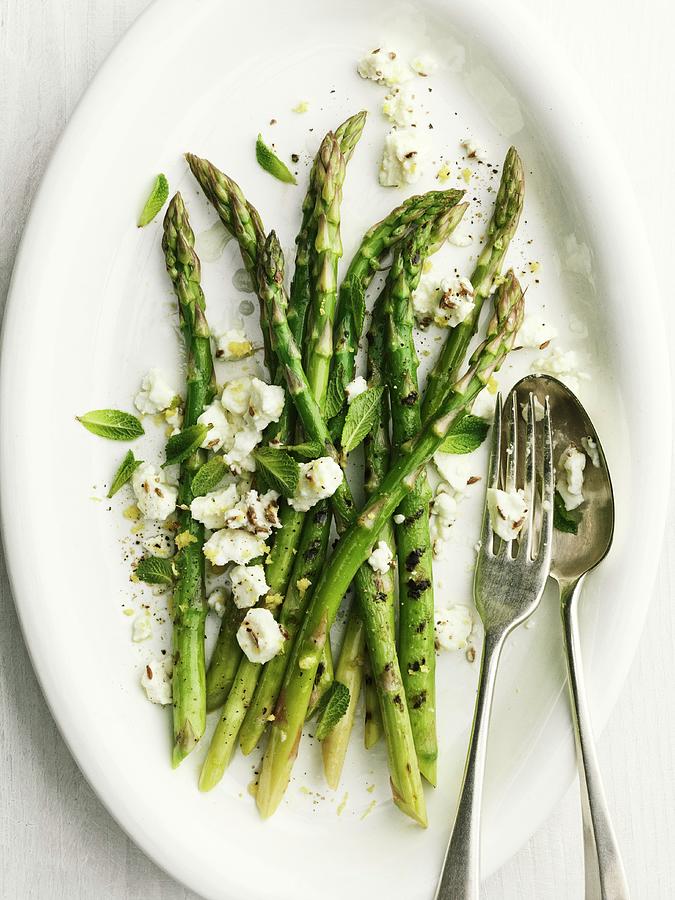 Grilled Green Asparagus With Sheeps Cheese And Cutlery Photograph by Jonathan Gregson