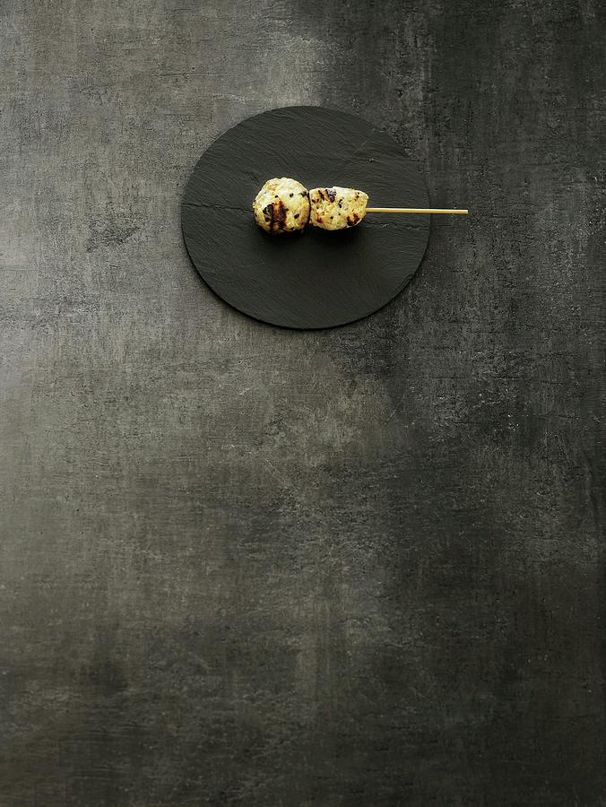 Grilled Meat Kushi On A Wooden Stick On A Round Slate Platter Photograph by Mikkel Adsbl