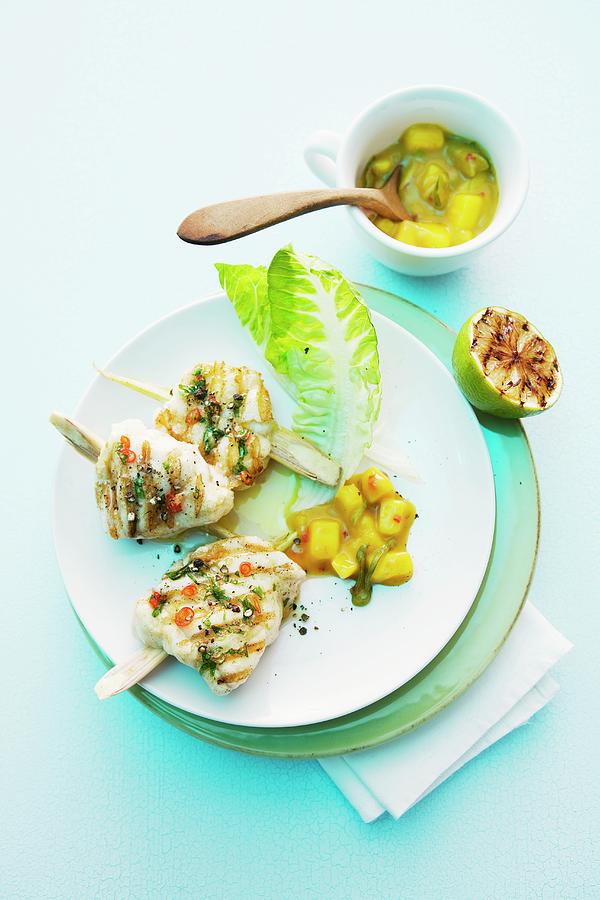 Grilled Monk Fish Medallions Speared On Sticks Of Lemongrass With A Mango And Leek Sauce Photograph by Michael Wissing