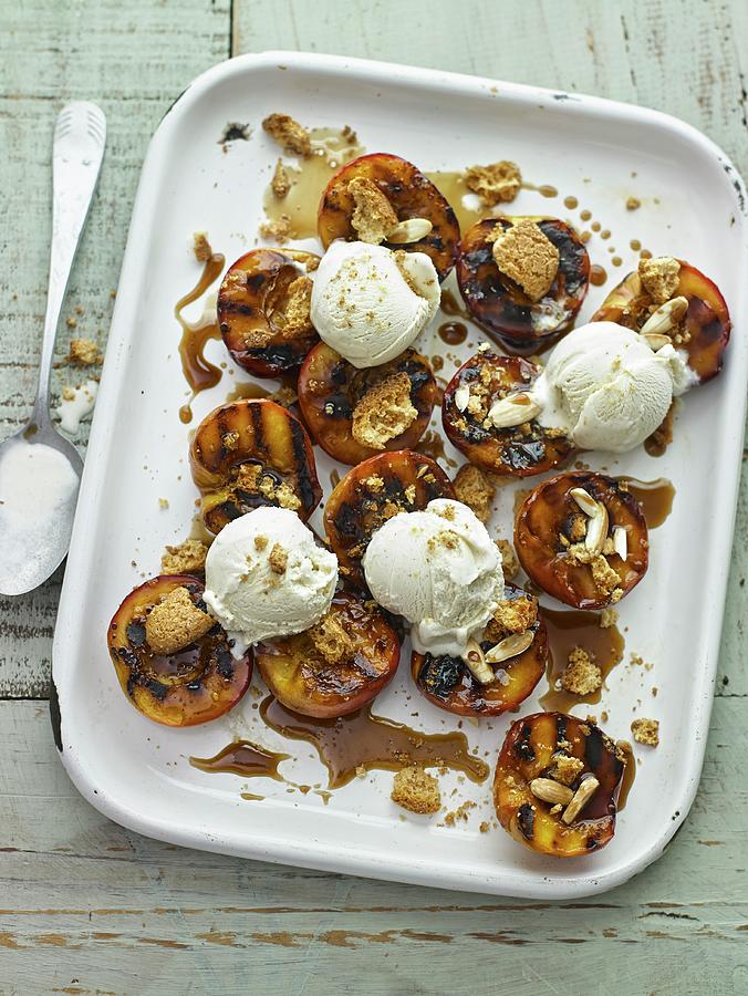 Grilled Peaches With Amaretto And Brown Sugar And Amaretti Biscuits And Whipped Cream Photograph by Dan Jones