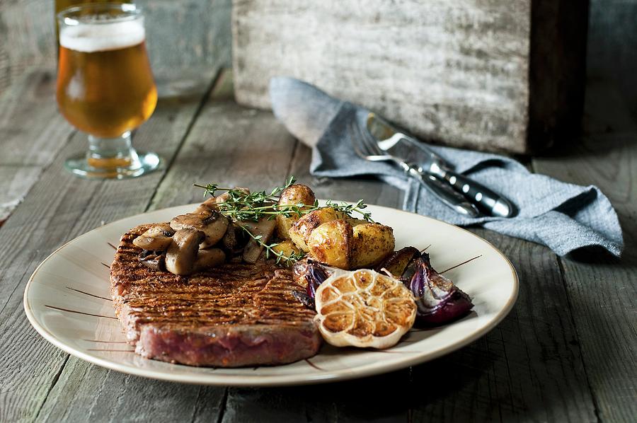 Grilled Rib Eye Steak With Red Onions, Garlic, Mushrooms And Thyme Potatoes Photograph by Tomasz Jakusz