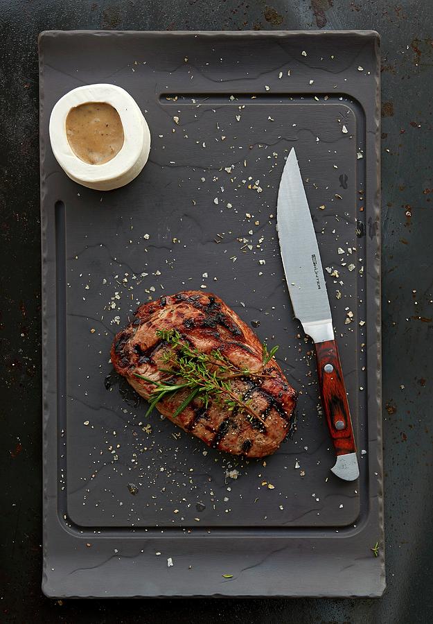Grilled Ribeye Steak With Sauce Photograph by Robbert Koene