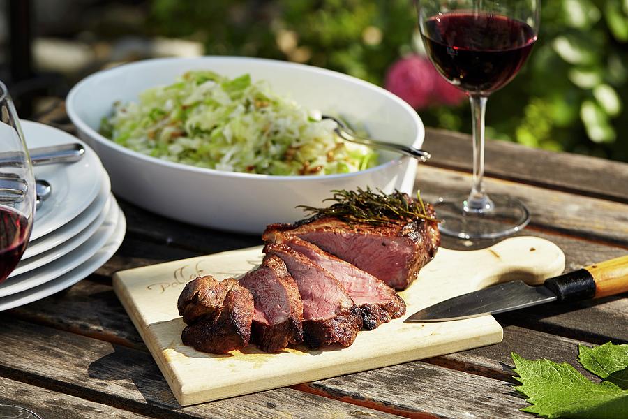 Grilled Sirloin With A Cabbage Salad On A Garden Table Photograph by Herbert Lehmann