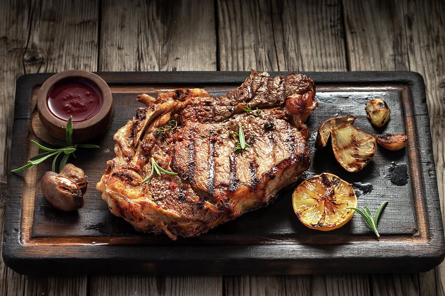 Grilled T-bone Steak On A Serving Board Photograph by Andrey Maslakov