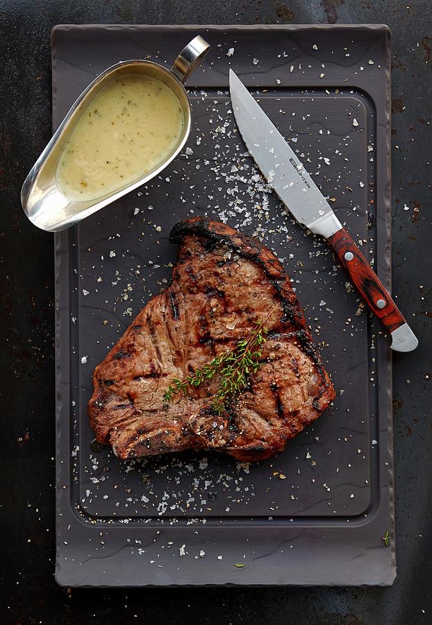 Grilled T-bone Steak With Gravy Photograph by Robbert Koene
