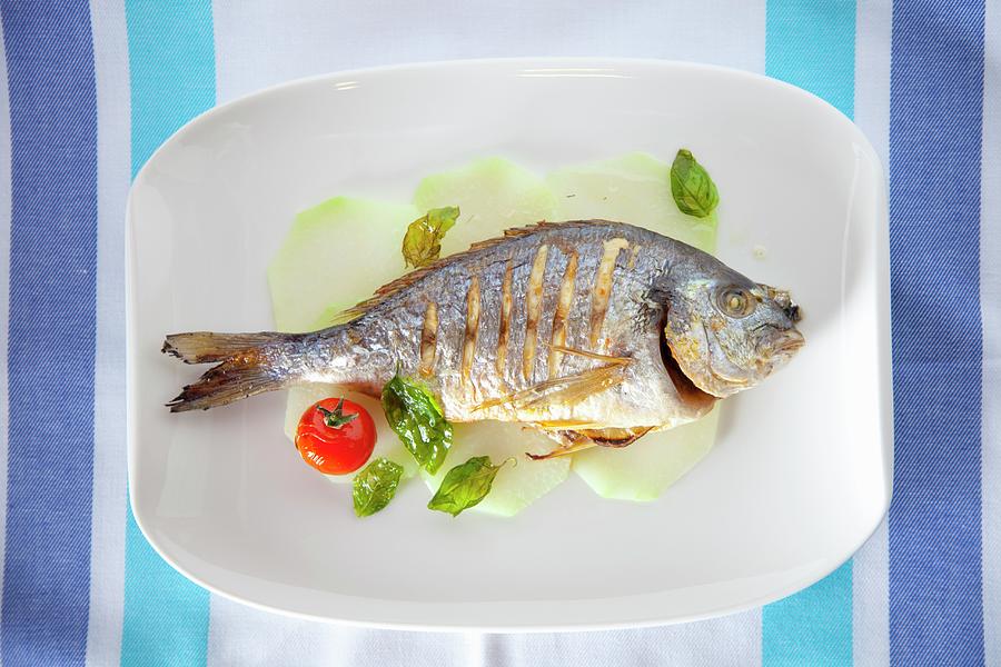 Grilled Tilapia With Cherry Tomatoes And Basil Photograph by Studio Lipov