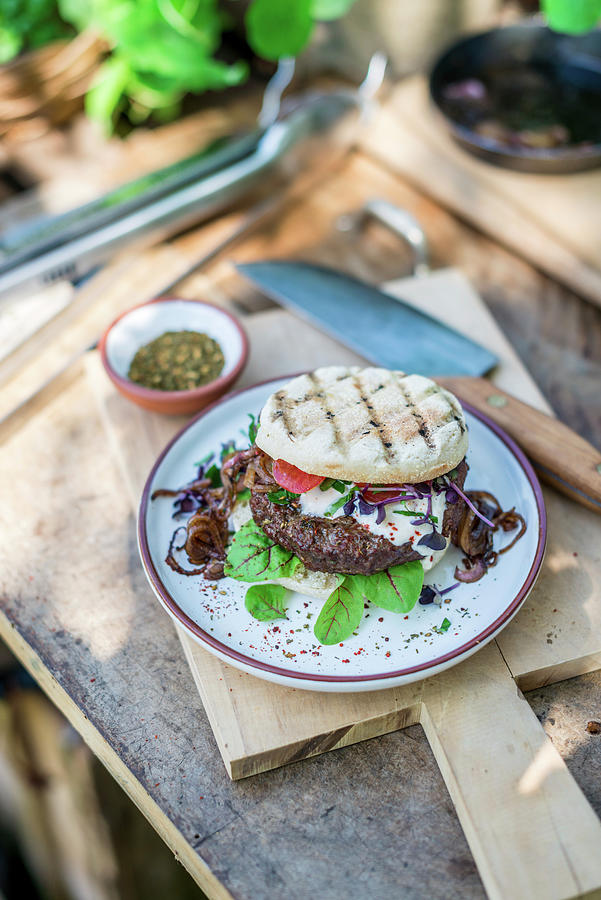 Grilled Zaatar Beef Burger On A Table Outside Photograph by Sebastian Schollmeyer
