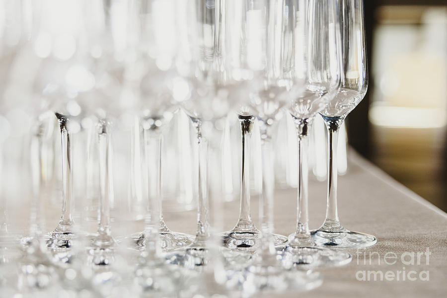 Group of empty and transparent champagne glasses in a restaurant.Group of empty and transparent champagne glasses in a restaurant. Photograph by Joaquin Corbalan