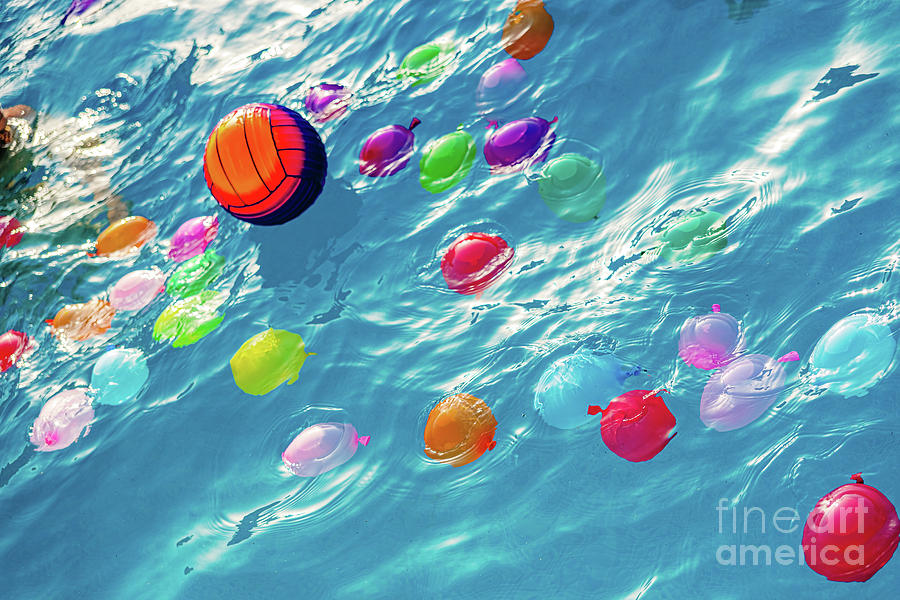 Group of many colorful plastic water balloons floating in the wa Photograph by Joaquin Corbalan