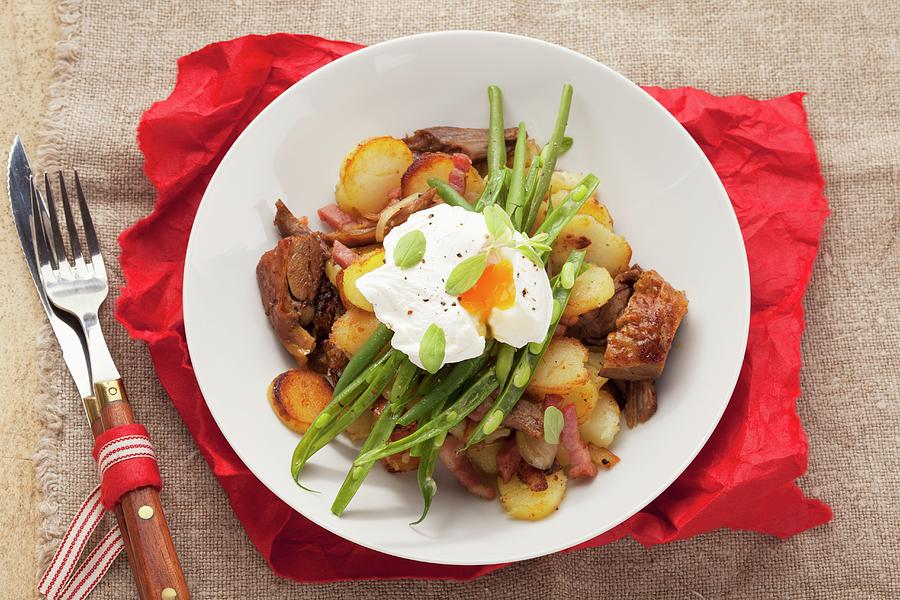 Grstl typical Tirolean Dish Using Leftovers With Potatoes, Pork, Green Beans And A Poached Egg Photograph by Eising Studio - Food Photo & Video