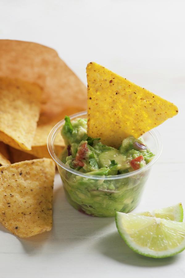 Guacamole With Tomato Piece And Coriander Served With Tortilla Chips Photograph by Laurange