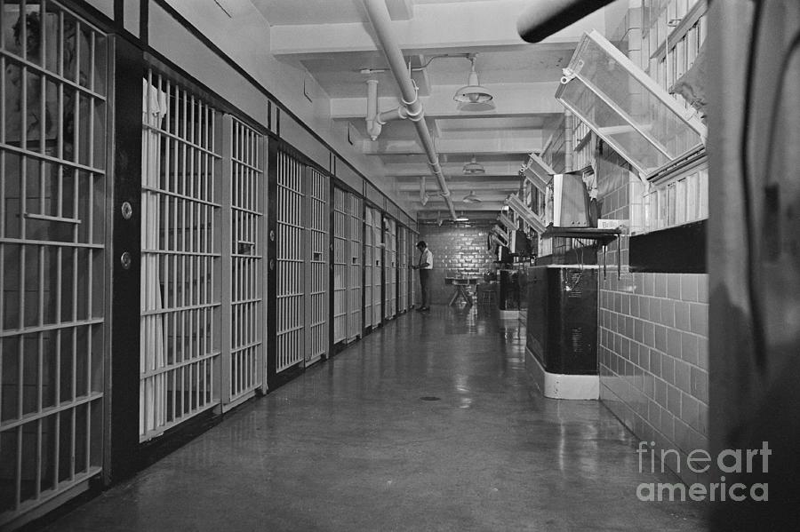 Guard Standing In Hallway Of Prison Photograph by Bettmann