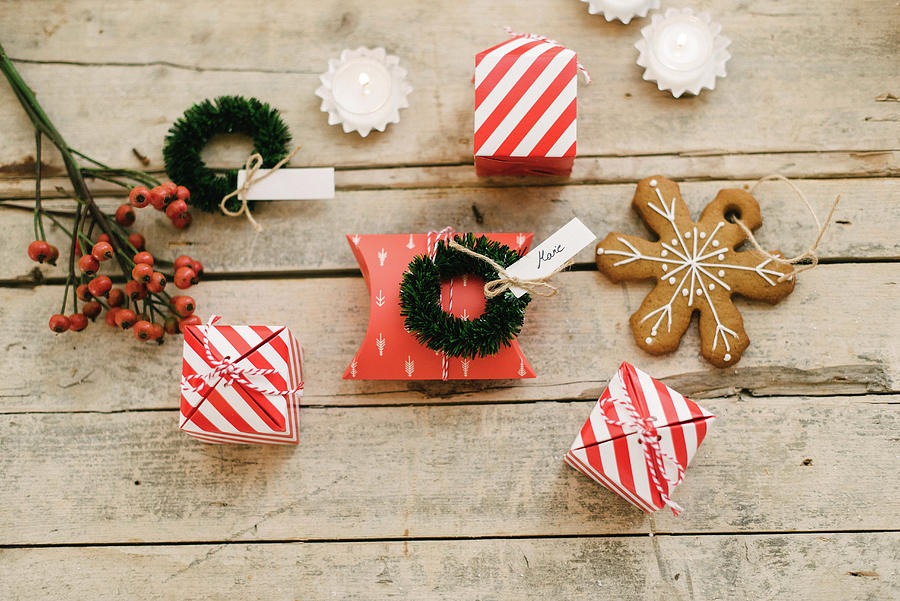 Guest Favours In Read-and-white Striped Boxes, Gingerbread Christmas-tree Decoration And Small Wreath Photograph by Katja Heil