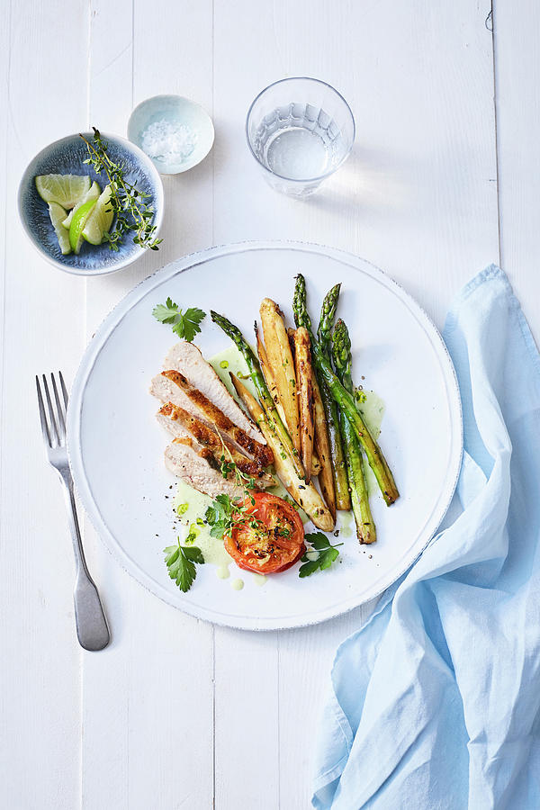 Guinea Fowl Breast With Mixed Asparagus And Ginger Tomatoes Photograph by Stockfood Studios /  Thorsten Suedfels