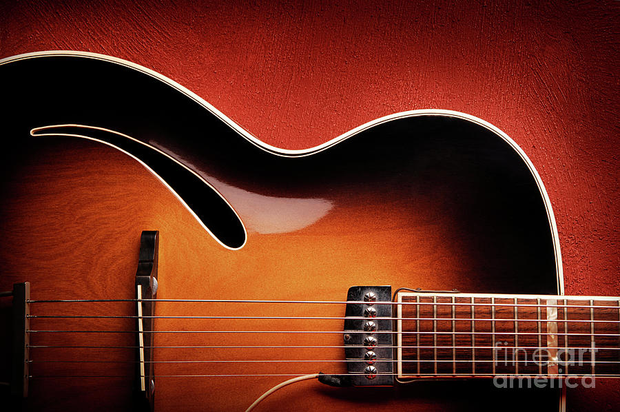 Guitar Leaning Against Red Wall Photograph by Westend61