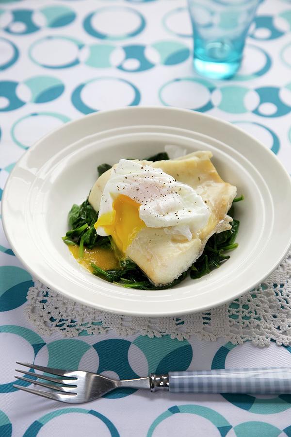 Haddock On A Bed Of Wilted Spinach Topped With A Poached Egg Photograph by Joy Skipper Foodstyling