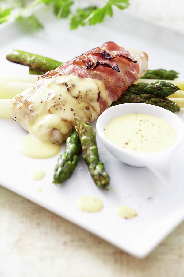 Hake Wrapped In Bacon With Asparagus And Hollandaise Sauce Photograph by Kirchherr, Jo