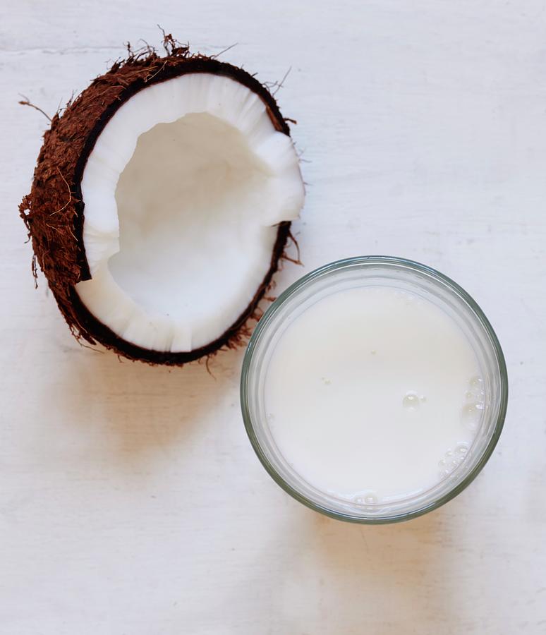 Half A Coconut And A Glass Of Coconut Milk Photograph by Ria Osborne ...