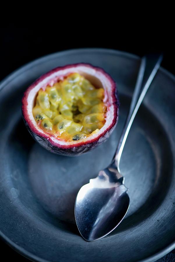 Half A Passion Fruit On A Pewter Plate With A Silver Spoon Photograph by Jamie Watson