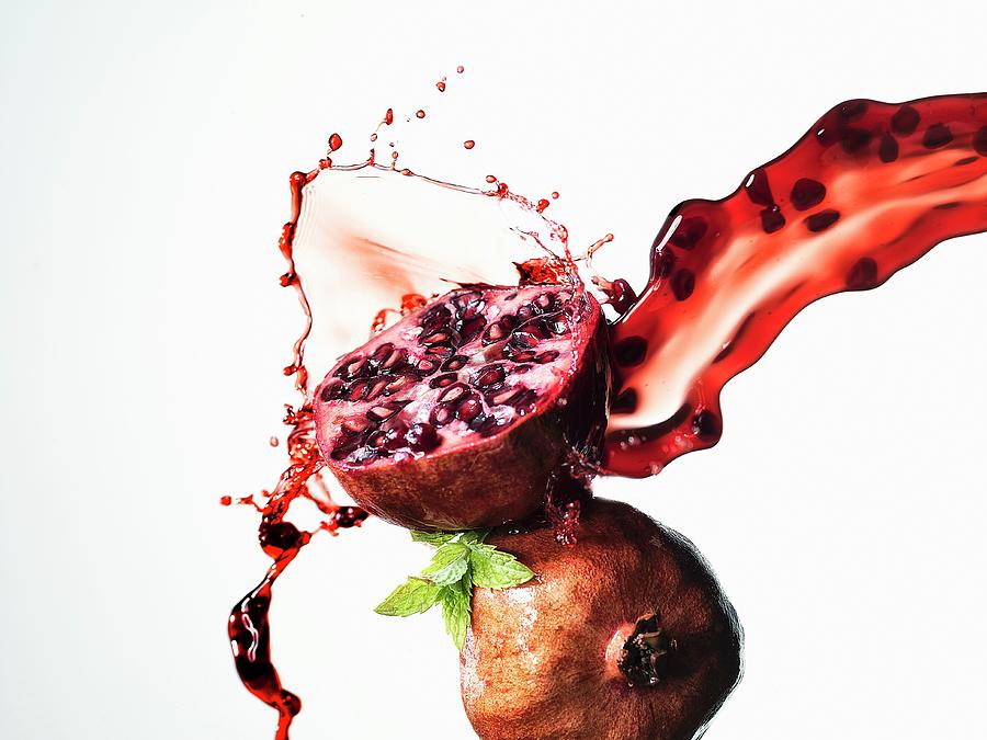 Half A Pomegranate With A Splash Of Juice Photograph by Waldecker, Axel