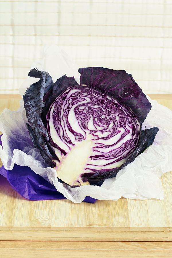 Half A Red Cabbage On A Piece Of White Paper Photograph by Miriam Rapado