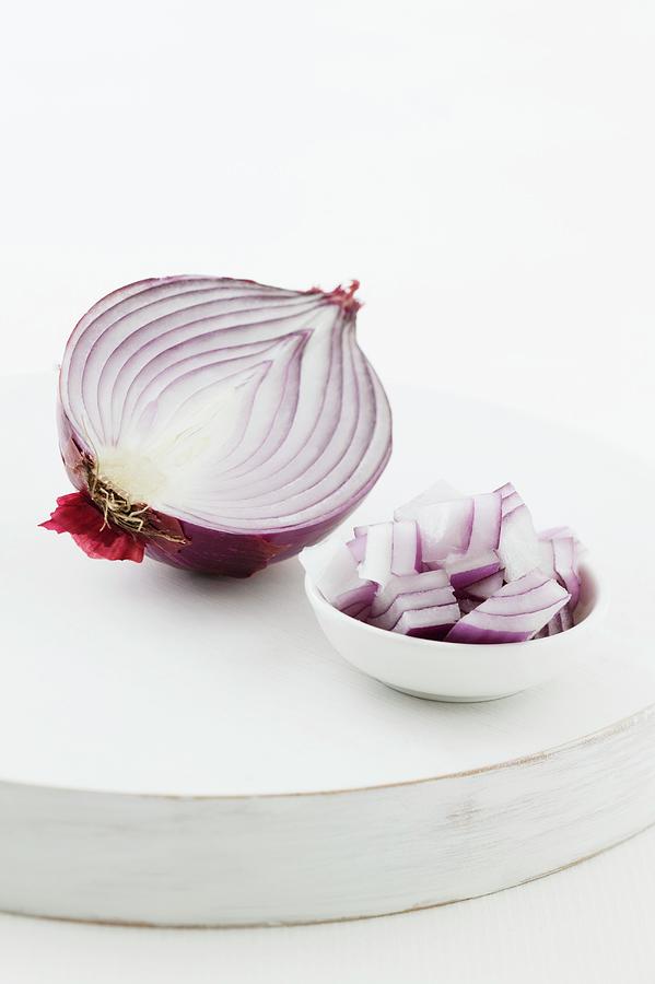 Half A Red Onion, And Pieces Of Onion In A Bowl Photograph by Young, Andrew