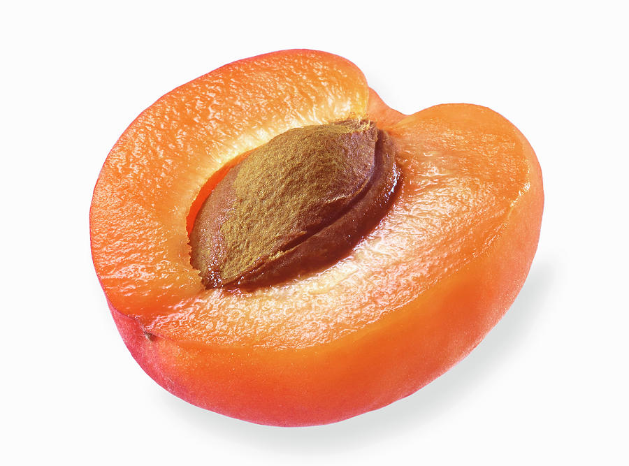 Half An Apricot On A White Surface Photograph by Fruitbank