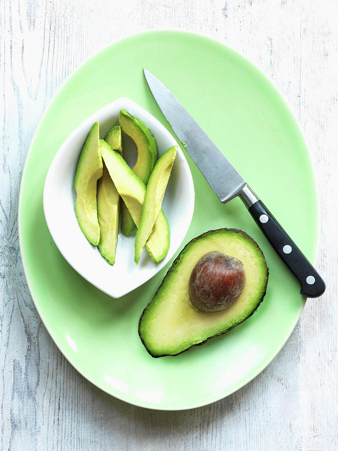 Half Avocado With Knife Photograph by Michael Paul