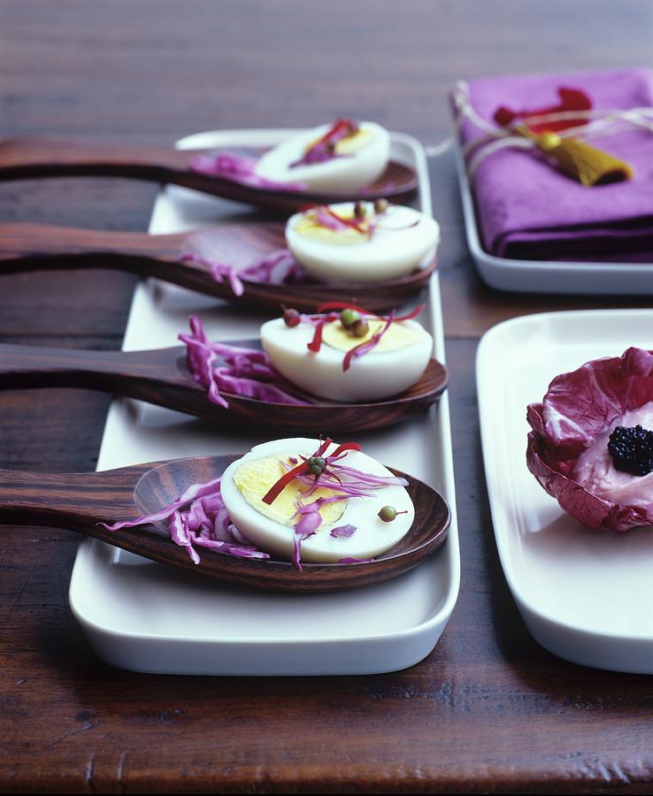 Half Boiled Eggs With Red Cabbage On Wooden Spoons Photograph by Matteo Manduzio