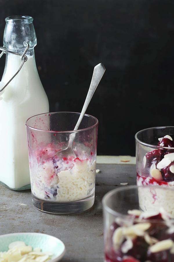 Half Eaten Rice Pudding With Cherries And Flaked Almonds Photograph by Zita Csig