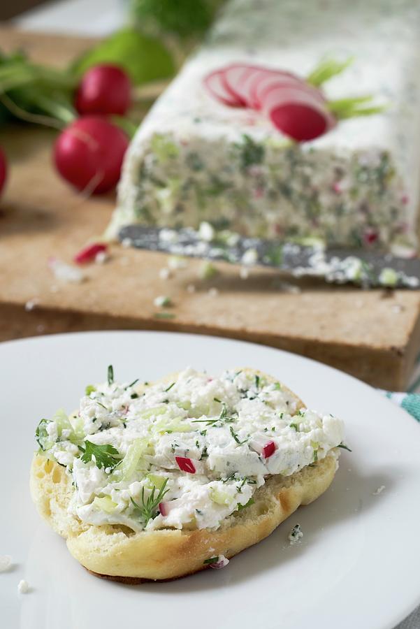 Half Of A Roll With Quark Cheese And Herbs Terrine Spread On A White Plate Photograph by Edyta Girgiel